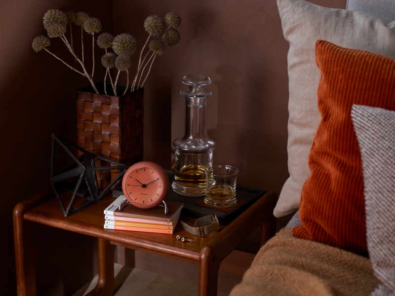 Arne Jacobsen City Hall Table Clock in Pale Orange in an interior setting