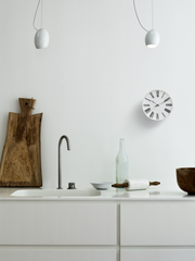 Arne Jacobsen Roman Wall Clock in White and Black in an interior setting