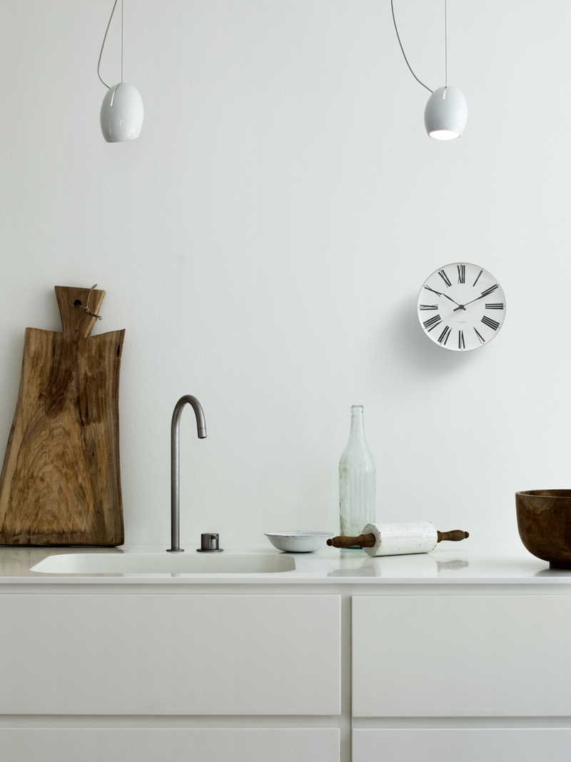 Arne Jacobsen Roman Wall Clock in White and Black in an interior setting