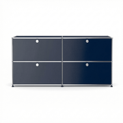 USM Haller Credenza E2 in navy blue with four drop-down doors, chrome frame, and modern modular storage design on a white background.